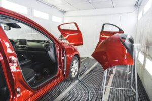 Red luxury car having fresh paint dry