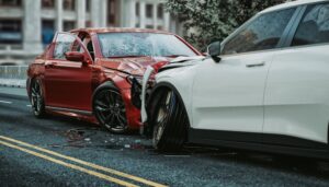 car accident between a red and white car