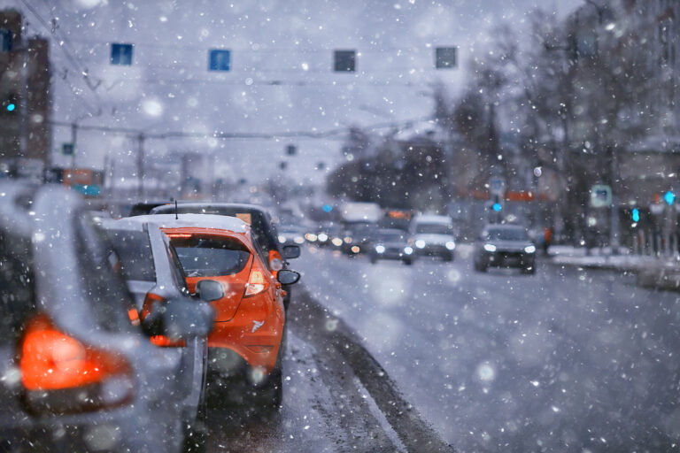 Vehicles waiting for a red light during the winter